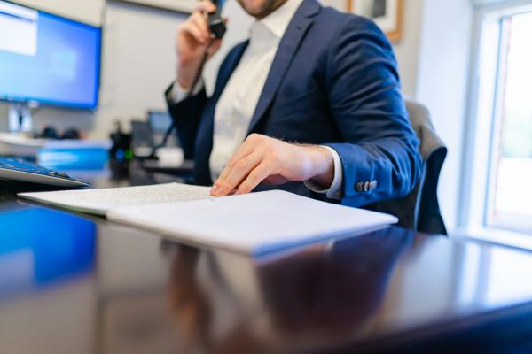 Mortgage professional reviewing documents at a desk.